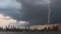 Dramatic lightning strike over city skyline at dusk Royalty Free Stock Photo