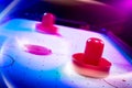 Dramatic lit air hockey table with light trails