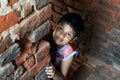 Dramatic look of a child. Portrait of a child. A child is playing Hide-and-seek on the top of the stairs.