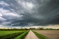 Dramatic looking thundercloud over a country road