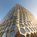 Tall Golden Hexagonal Skyscraper Against Blue Sky building architecture Royalty Free Stock Photo