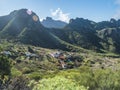 Dramatic lush green picturesque valley with old village Los Carrizales . Landscape with sharp rock formation, hills and