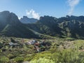 Dramatic lush green picturesque valley with old village Los Carrizales . Landscape with sharp rock formation, hills and