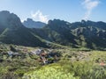 Dramatic lush green picturesque valley with old village Los Carrizales . Landscape with sharp rock formation, hills and