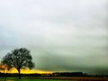 Dramatic misty sunset over a field Royalty Free Stock Photo