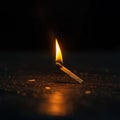 A dramatic moment a matchstick lights up a brown wooden surface