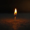 A dramatic moment a matchstick lights up a brown wooden surface