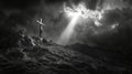 Dramatic monochrome cross on rocky hill with storm clouds and sunbeam Royalty Free Stock Photo