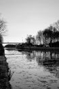 Dramatic and monochrome sunrise over a Beautiful early winter landscape with a frozen river