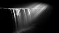 Dramatic Monochrome Waterfall with Light Rays Royalty Free Stock Photo