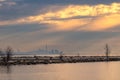 Dramatic moody sunrise light with sun rays over Lake Ontario with the Toronto skyline in the background