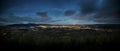 Dramatic moon sky with illuminated clouds in the mountains. Dark black silhouette of mountain ridge and Jested transmitter tower