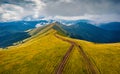 Dramatic morning view from flying drone of Svydovets mountain range with old country road. Royalty Free Stock Photo