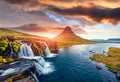 Dramatic morning view of popular tourast destination - Kirkjufellsfoss Waterfall. Exciting summer sunrise on Snaefellsnes peninsul