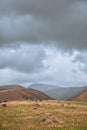 Dramatic mountain valley under a cloudy sky with a rugged landscape Royalty Free Stock Photo
