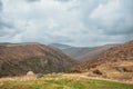 Dramatic mountain valley under a cloudy sky with a rugged landscape Royalty Free Stock Photo