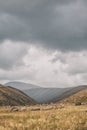 Dramatic mountain valley under a cloudy sky with a rugged landscape Royalty Free Stock Photo