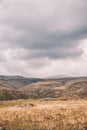 Dramatic mountain valley under a cloudy sky with a rugged landscape Royalty Free Stock Photo