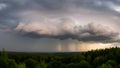 Dark storm clouds over green forest with rain dark clouds Royalty Free Stock Photo