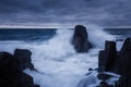 Dramatic nature background - big waves and dark rock in stormy sea, stormy weather. Dramatic scene.