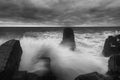 Dramatic nature background - big waves and dark rock in stormy sea, stormy weather. Dramatic scene. Royalty Free Stock Photo