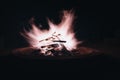 Dramatic night scene of a burning fire pit, emitting smoke and glowing with flickering flames Royalty Free Stock Photo