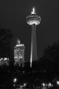 Dramatic night scene of the Skylon Tower Niagara Falls and nearby buildings, black and white