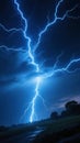 A dramatic night sky illuminated by a powerful lightning strike showcasing vivid blue electrical arcs against dark clouds and a Royalty Free Stock Photo