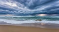 Dramatic ocean storm clouds over sandy beach and crashing waves at sunset Royalty Free Stock Photo