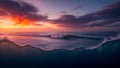 Dramatic Ocean Waves Under a Fiery Sunset Sky with Swirling Clouds and Deep Blue Underwater View Royalty Free Stock Photo