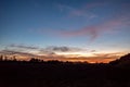 Dramatic orange and blue cloud and sky after storm and raining over agricultural field Royalty Free Stock Photo