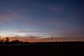 Dramatic orange and blue cloud and sky after storm and raining over agricultural field Royalty Free Stock Photo