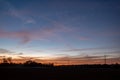 Dramatic orange and blue cloud and sky after storm and raining over agricultural field Royalty Free Stock Photo