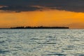 Dramatic orange tinged Sunset in the Bohol Strait. Silhoutte of Bugatusan Island, a small inhabited islet off the town of Inabanga