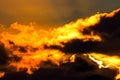 Dramatic orange and yellow sunset sky behind a range of majestic mountain peaks Royalty Free Stock Photo