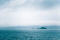 A dramatic, overcast scenery on the coeast of fjord during a ferry ride in Norway near Bergen.