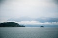 A dramatic, overcast scenery on the coeast of fjord during a ferry ride in Norway near Bergen.