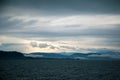 A dramatic, overcast scenery on the coeast of fjord during a ferry ride in Norway near Bergen.