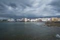 Dramatic overcast sky, low tide and calm waves in the town side of El Medano, Tenerife, Canary Islands, Spain