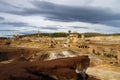 Dramatic overcast sky over ruined sulfur extraction ovens and chimneys Royalty Free Stock Photo