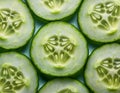A dramatic overhead shot of a sliced cucumber with overlapping pieces arranged in a concentric circular pattern