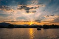 Dramatic panorama evening sky and clouds over mountain and lake at sunset