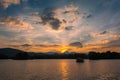 Dramatic panorama evening sky and clouds over mountain and lake at sunset