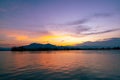 Dramatic panorama evening sky and clouds over mountain and lake at sunset Royalty Free Stock Photo