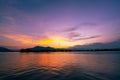 Dramatic panorama evening sky and clouds over mountain and lake at sunset Royalty Free Stock Photo