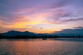 Dramatic panorama evening sky and clouds over mountain and lake at sunset Royalty Free Stock Photo