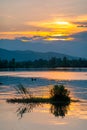 Dramatic panorama evening sky and clouds over mountain and lake at sunset