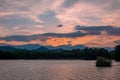 Dramatic panorama evening sky and clouds over mountain and lake at sunset Royalty Free Stock Photo