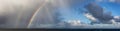 Dramatic Panoramic View of a cloudscape with Rainbow Royalty Free Stock Photo