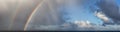 Dramatic Panoramic View of a cloudscape with Rainbow Royalty Free Stock Photo